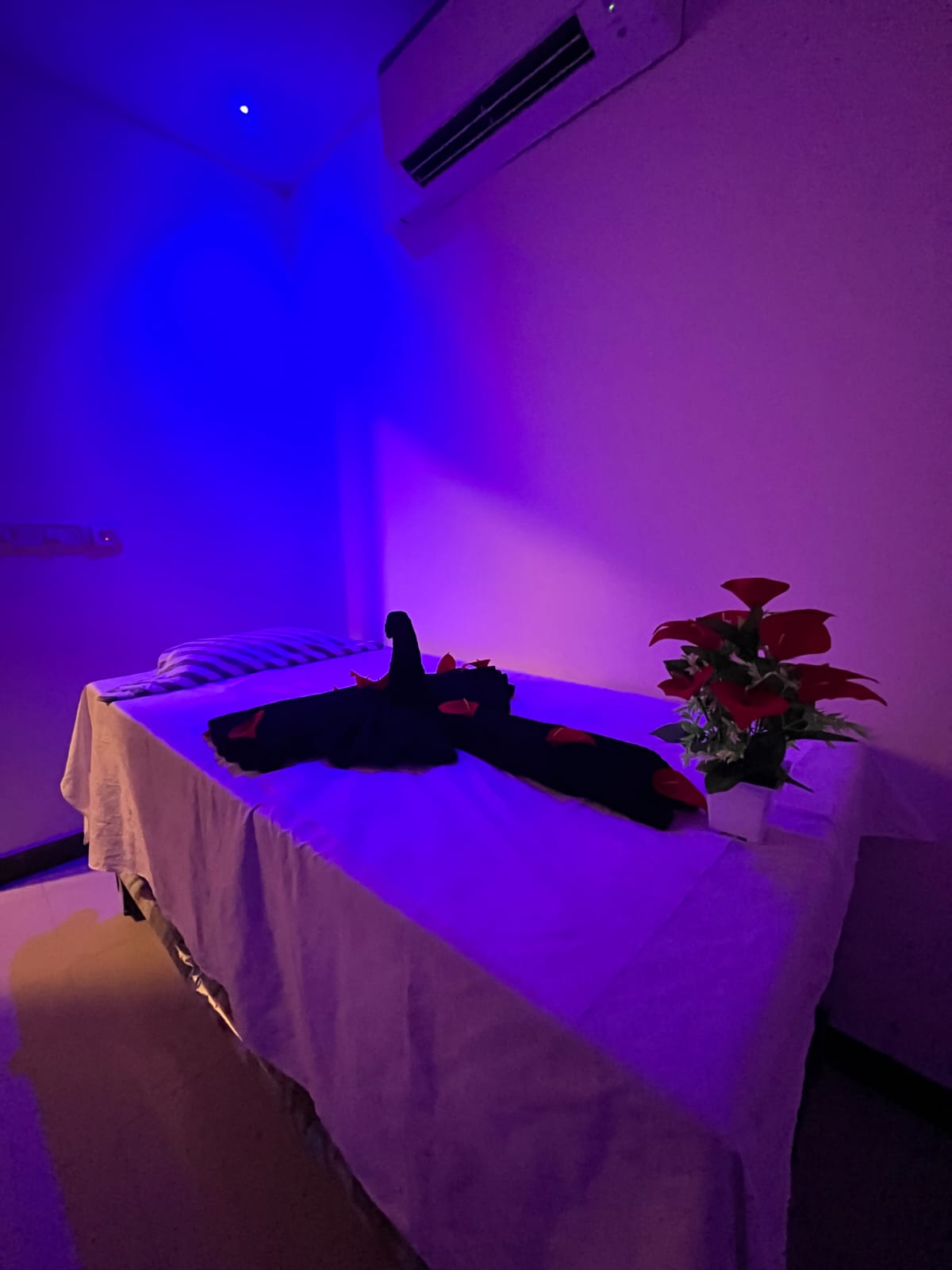 Spa treatment setup with towels and essential oils